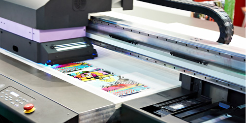 Принтер уф-печати в процессе выполнения заказа